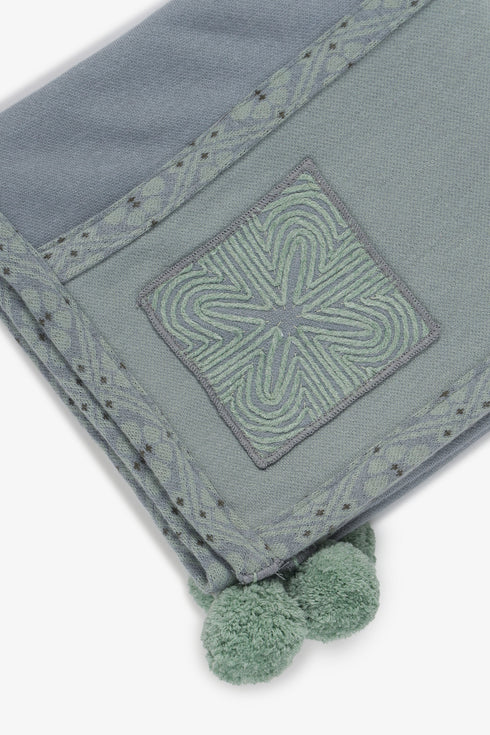 Embroidered jacquard shawl with pompom detailing