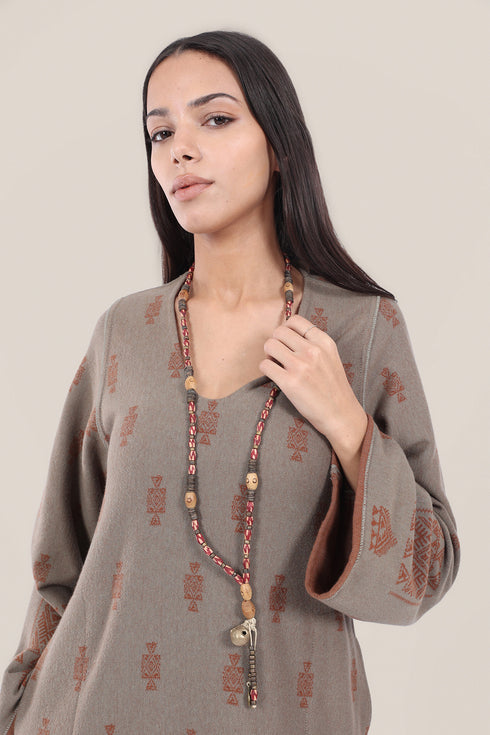 Long necklace with brass bell pendant