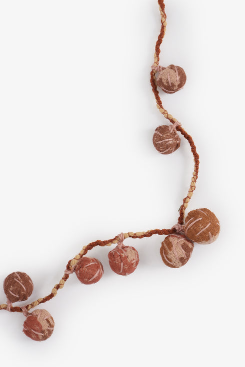 Adjustable fabric ball necklace with metal tassels