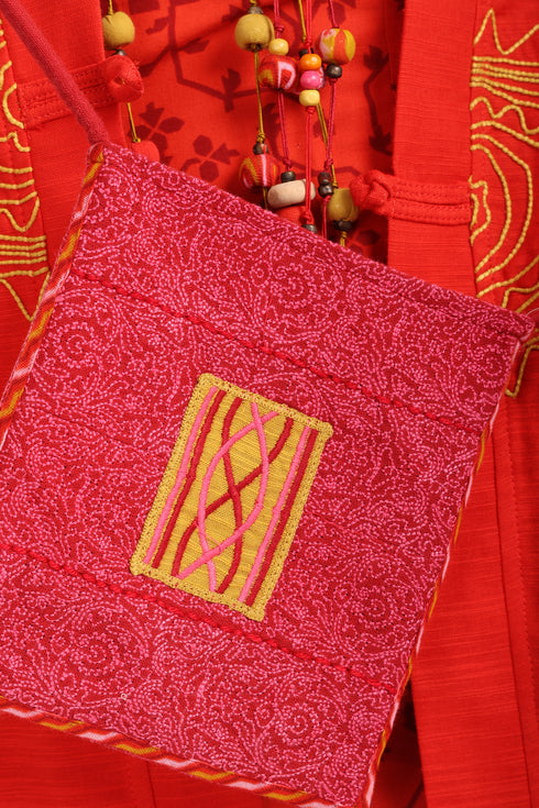 Small cross body bag with embroidered badge