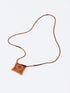Leather long necklace in leather with embroidered cotton pendant