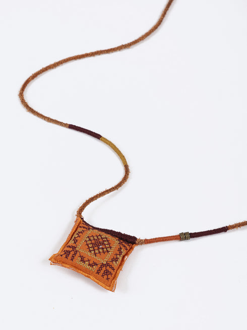 Leather long necklace in leather with embroidered cotton pendant